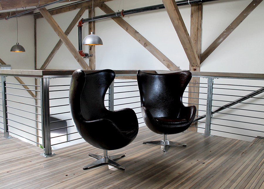 The mezzanine seating area featuring high-backed leather chairs